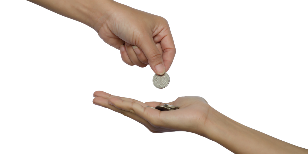 One hand giving some money to another hand.
